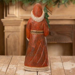 Hand carved elegant santa in red robe with white collar and gold belt holding green tree from bethany lowe designs santa figures