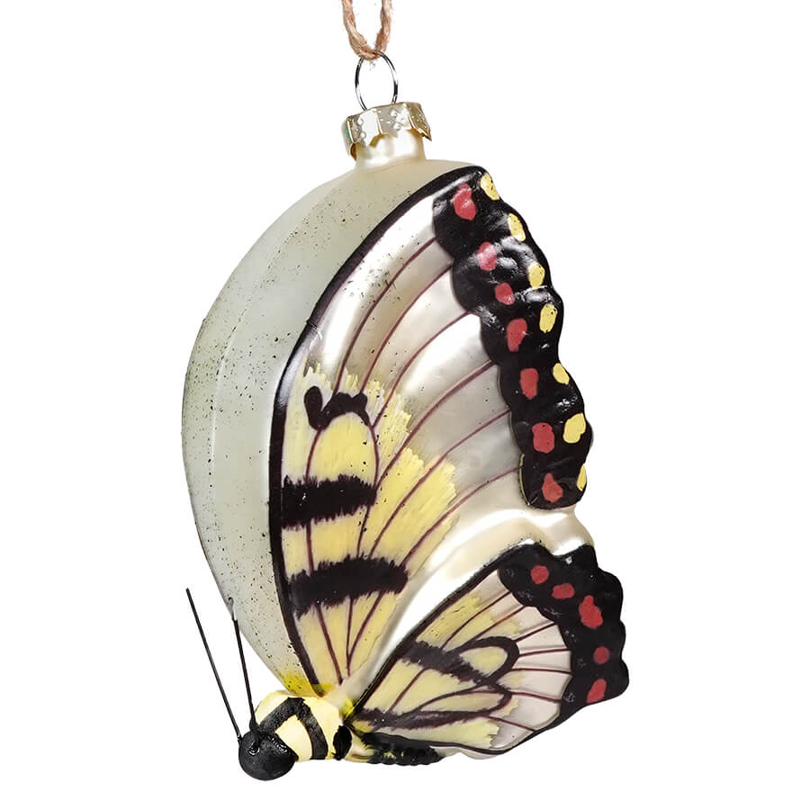 Butterfly-shaped Christmas tree ornament with delicate wing patterns.