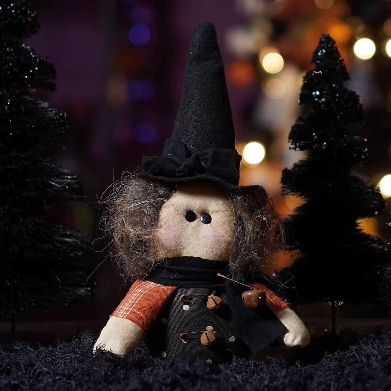 Handcrafted itty bitty witch doll with tall black felt hat curly yarn hair and patchwork outfit for figural decor or tree toppers