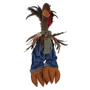 A handcrafted large sitting turkey figurine in brown with feathered wings wearing blue denim pants and a green scarf