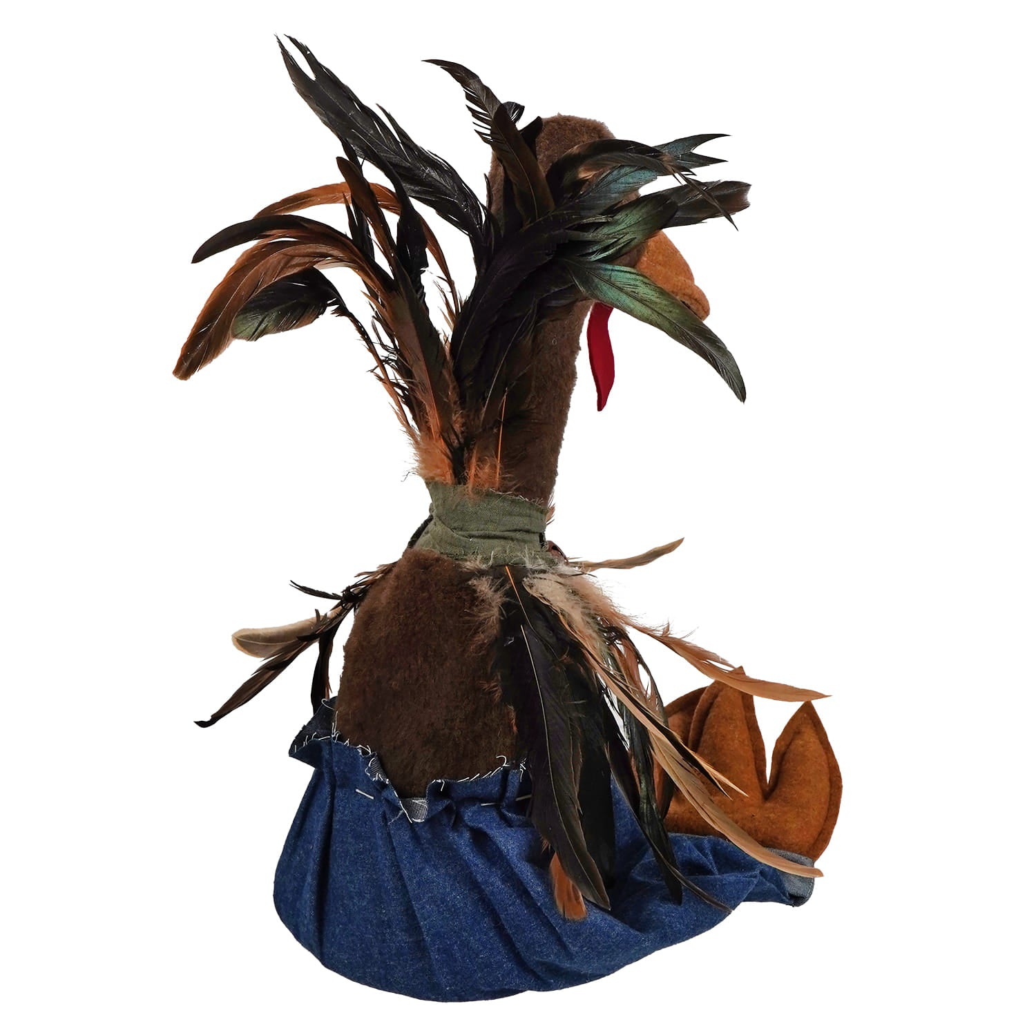 Handcrafted large sitting turkey with brown fur and black green tan feathers wearing a blue denim skirt pants