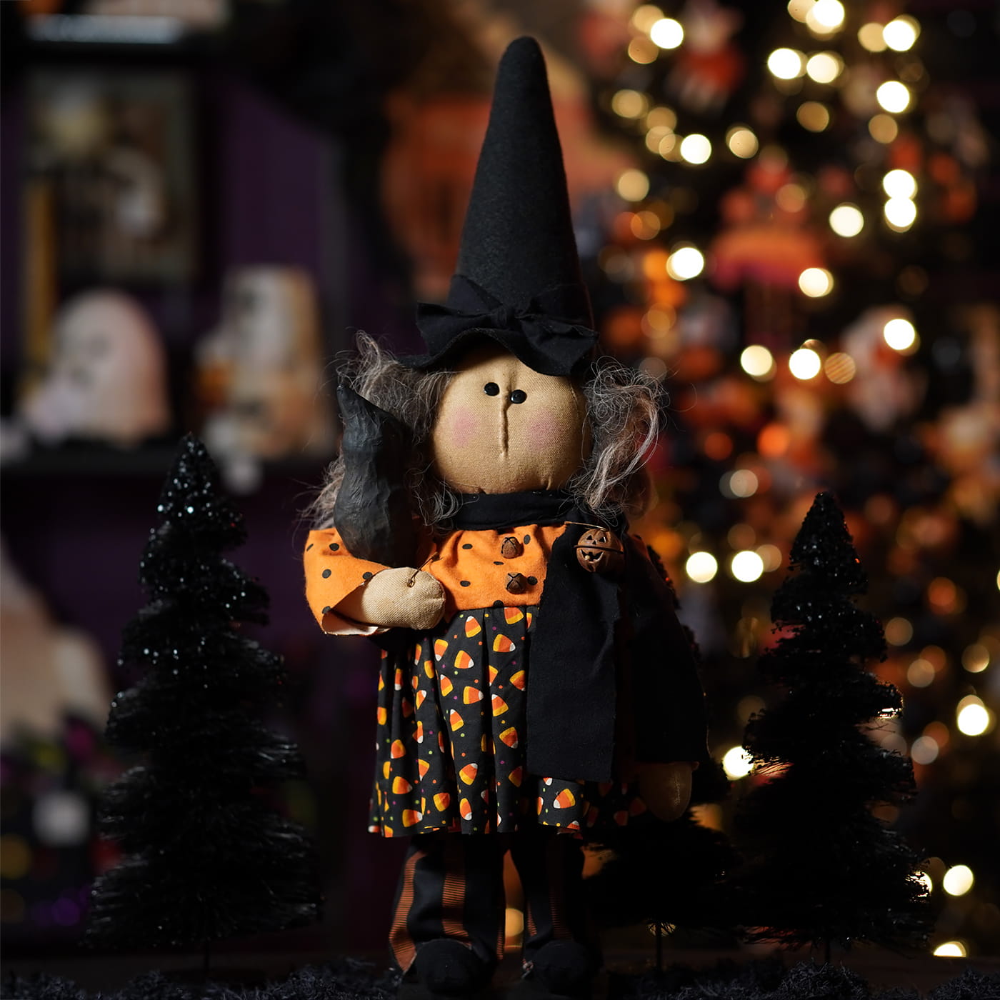 A handcrafted large standing candy corn dress witch doll with gray yarn hair and a tall black hat perfect for figural decor