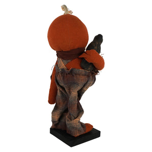 Handcrafted large orange pumpkin-headed albert standing scarecrow figurine with plaid trousers holding black crow bird