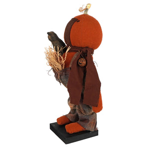 Handcrafted large standing fall colors scarecrow with orange pumpkin head brown fabric body and black crow figural decor