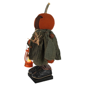 Handcrafted large standing fall colors scarecrow figurine with orange pumpkin head, green coat, black shoes, holding orange lantern