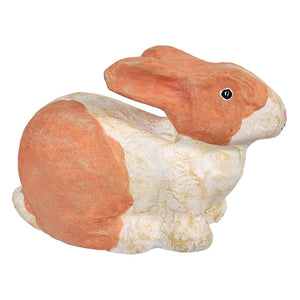 Ceramic or clay rabbit figurine painted in peach and white colors.