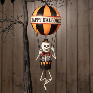 Happy halloween balloon featuring a skeleton decor figure in black and orange hot air balloon with happy halloween banner