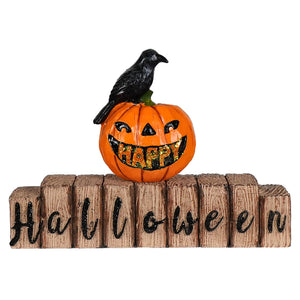 Happy halloween jack-o’-lantern tabletop decor featuring an orange pumpkin with carved face and black crow