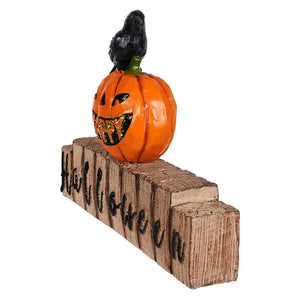 Happy halloween jack o’lantern with glittery teeth and black crow on halloween sign wooden block tabletop decor