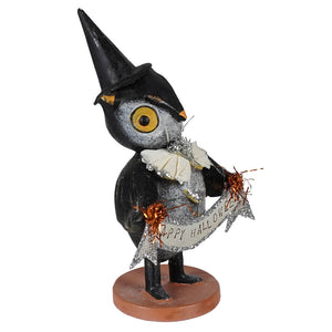 Black owl figurine wearing a pointed hat holding a glittery happy halloween banner bethany lowe halloween decor