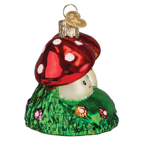 Happy mushrooms ornament featuring a glossy red mushroom house ornament with white spots on glittery green grass base