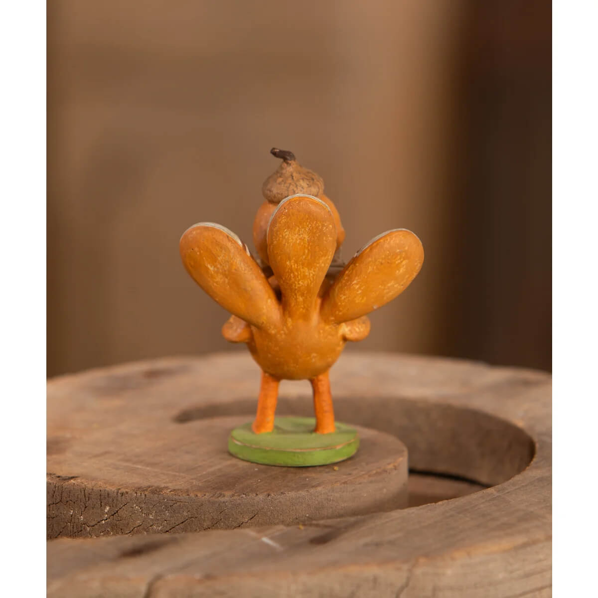 A charming orange turkey figure with acorn on head on green base by michelle lauritsen design bethany lowe thanksgiving