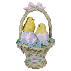 Pastel easter basket with woven wicker texture featuring hatching chicks and glittery decorated eggs easter tabletop decor