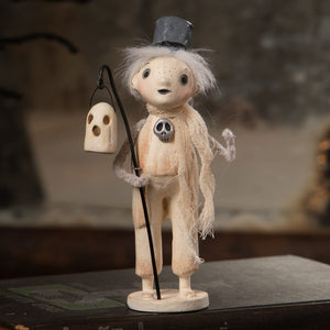 A whimsical cream-colored haunting henry halloween ghost figure decor with black top hat lantern and skull pendant