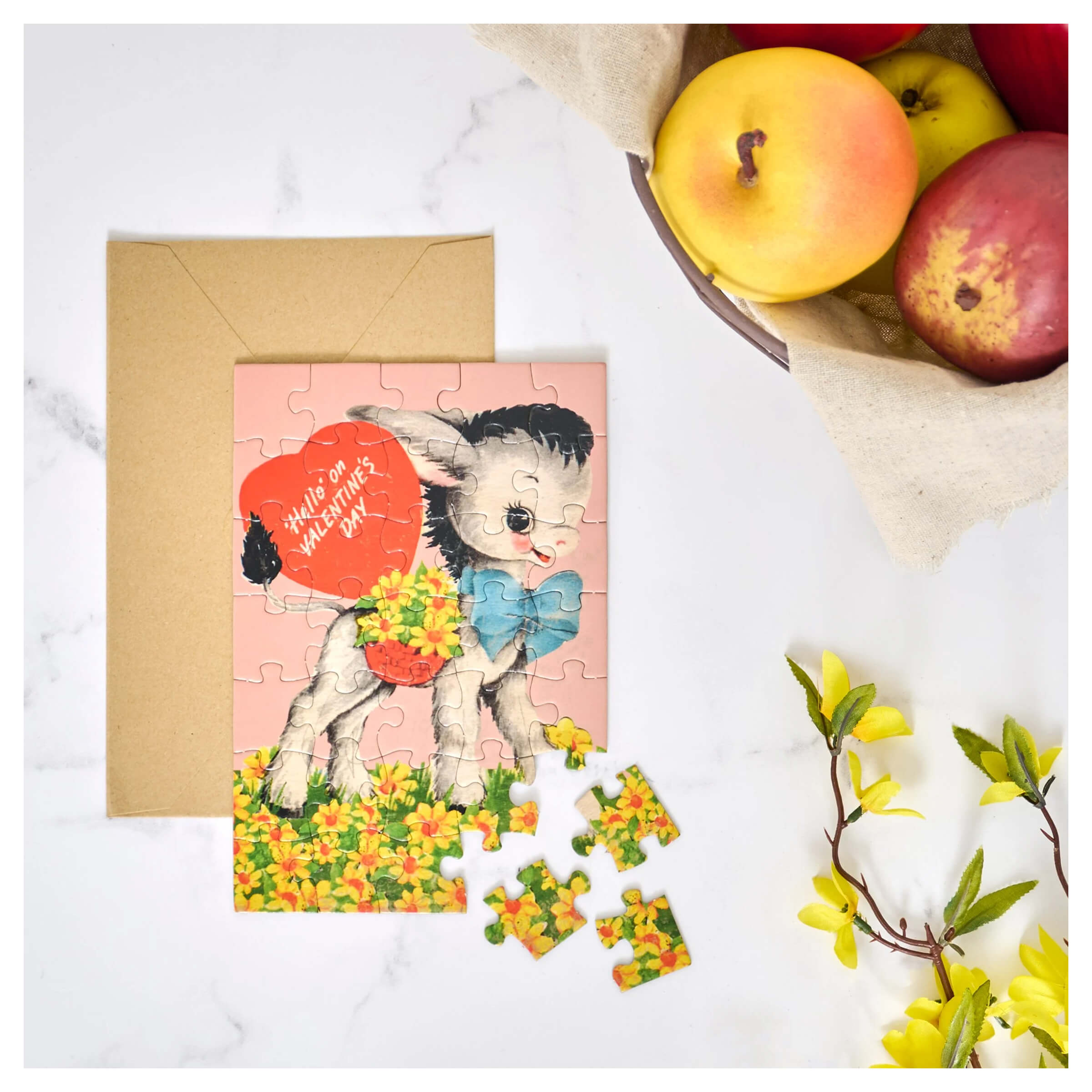 A pink valentine’s day holiday jigsaw puzzle featuring a cartoon donkey with a blue bow tie and heart-shaped basket