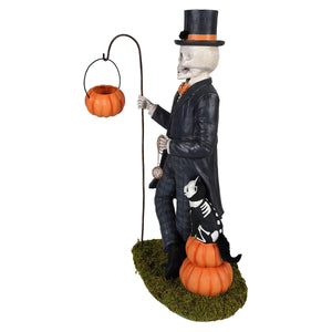 Henry deadison skeleton figurine wearing a black top hat with orange band holding a pumpkin lantern on a curved pole