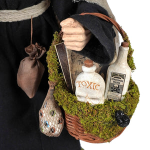 A rustic woven potion basket with green moss holding a white skull bottle labeled toxic and a strychnine poison bottle hildegard