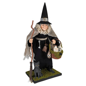 Hildegard halloween witch figurine holding a black cat and a potion basket in her hands