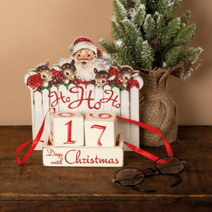 White wooden ho ho ho block countdown calendar with santa and reindeer cutouts showing 17 days until christmas