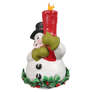 A festive white holly berry snowman figurine with green gloves and red scarf holding a tall red candle by bethany lowe designs