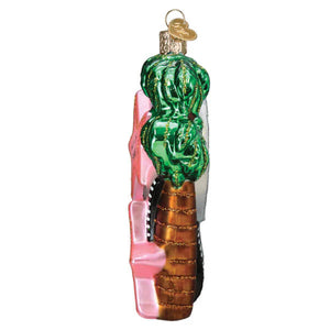 Green ice cream with gold glitter swirls on a brown cone inside a hollywood walk of fame christmas glass ornament