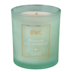 A mint green frosted glass homemade gingerbread candle jar with gold label and white soy wax by creative co-op