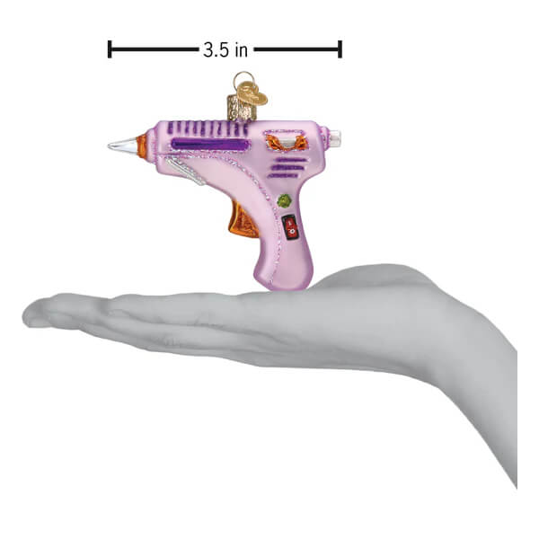 Pink glass glue gun ornament with purple accents and gold details perfect as a christmas glass ornament