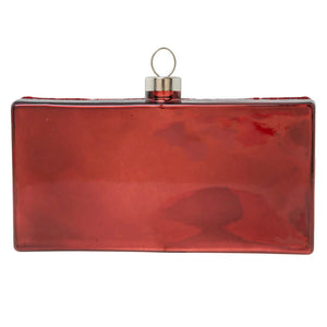 A glossy red rectangular clutch with a metallic silver loop featured in the hot tamales® box ornament collection