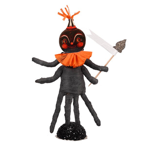 Black halloween-themed spider figure with orange accents and party hat holding sparkly flag in collaboration with johanna parker