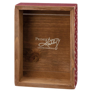 Wooden display box with ’Primitives’ text engraved on the back panel.