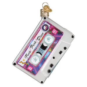 A glittery translucent glass christmas glass ornament shaped like a vintage cassette tape with funk pure disco label and iridescent accents perfect as a 70s ornament