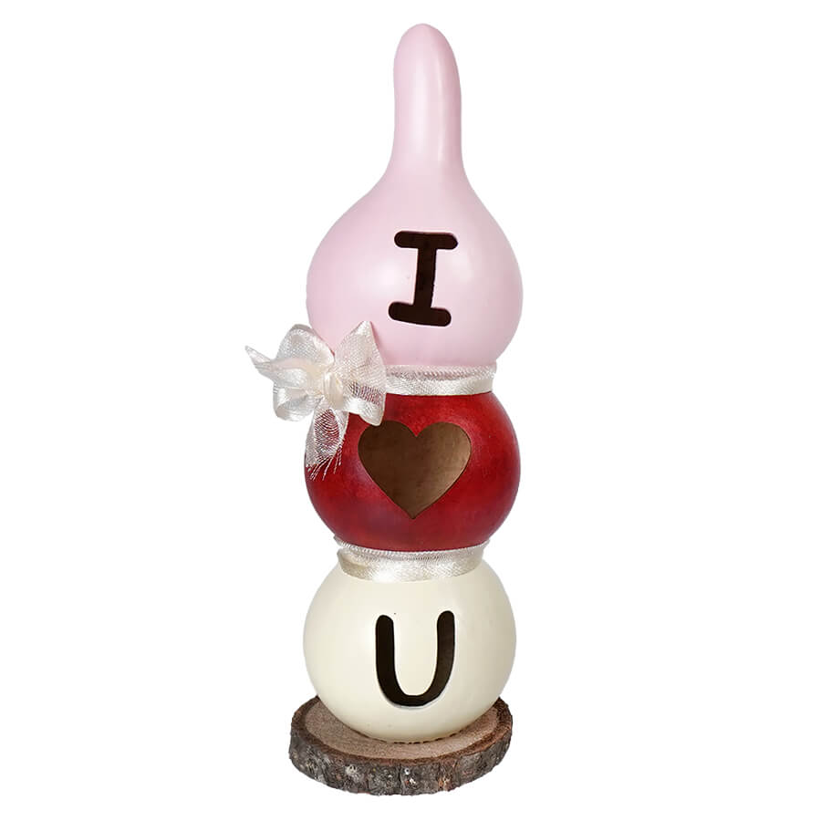 Stacked decorative gourds spelling ’I ❤️ U’ with a white bow accent.