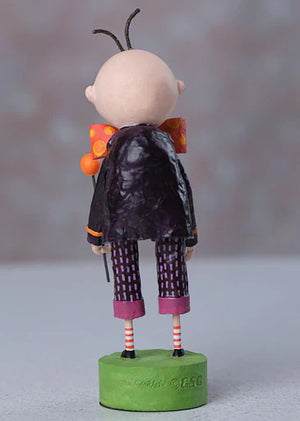 A lori mitchell halloween igor figurine of a bald character with antennae wearing a glossy black coat and purple pants