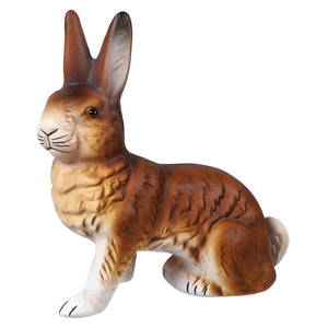 A detailed brown and white ceramic rabbit figurine with textured fur in a sitting pose by ino schaller brown