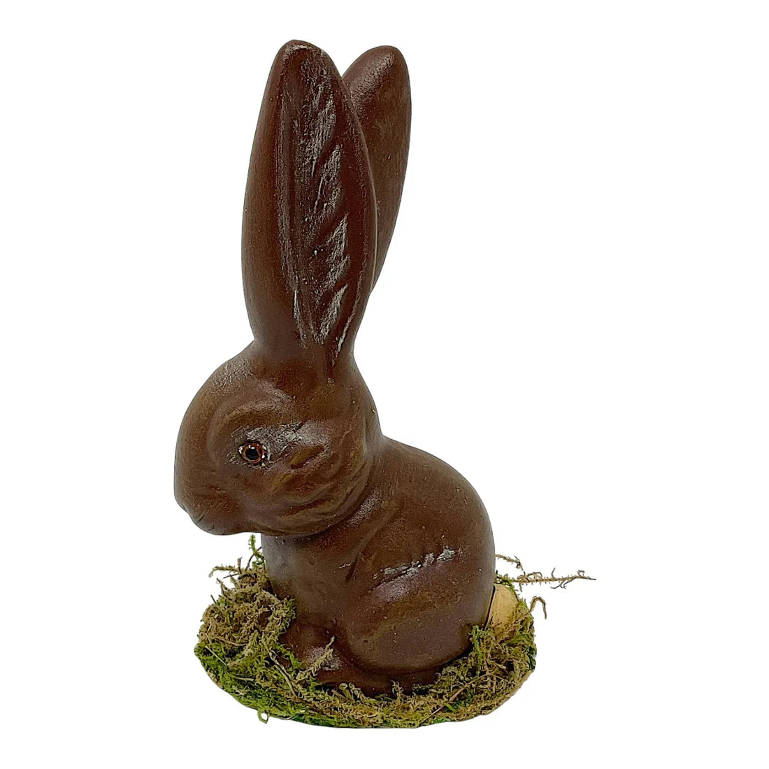 A glossy ino schaller brown sitting easter bunny made of paper mache with detailed ears on green moss