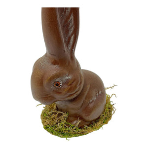 A glossy brown ino schaller paper mache sitting easter bunny rabbit on green moss for decoration
