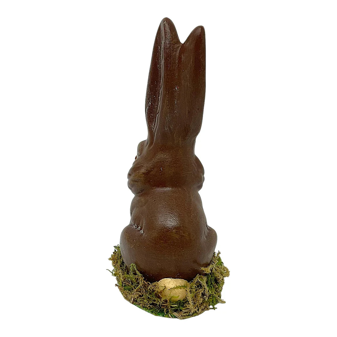 Glossy dark chocolate ino schaller brown paper mache sitting easter bunny on green moss with small golden egg