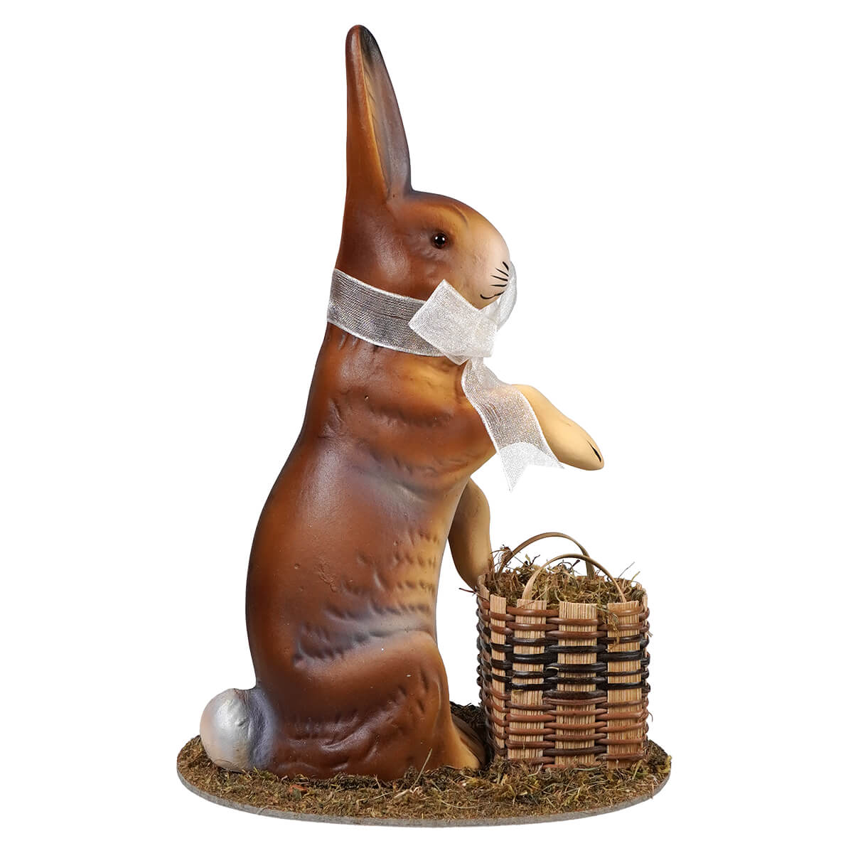 Ino schaller brown resin Easter bunny figurine with white bow standing beside wicker basket filled with hay