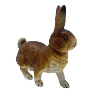A detailed brown ceramic ino schaller walking easter bunny rabbit figurine with a glossy finish made of paper mache