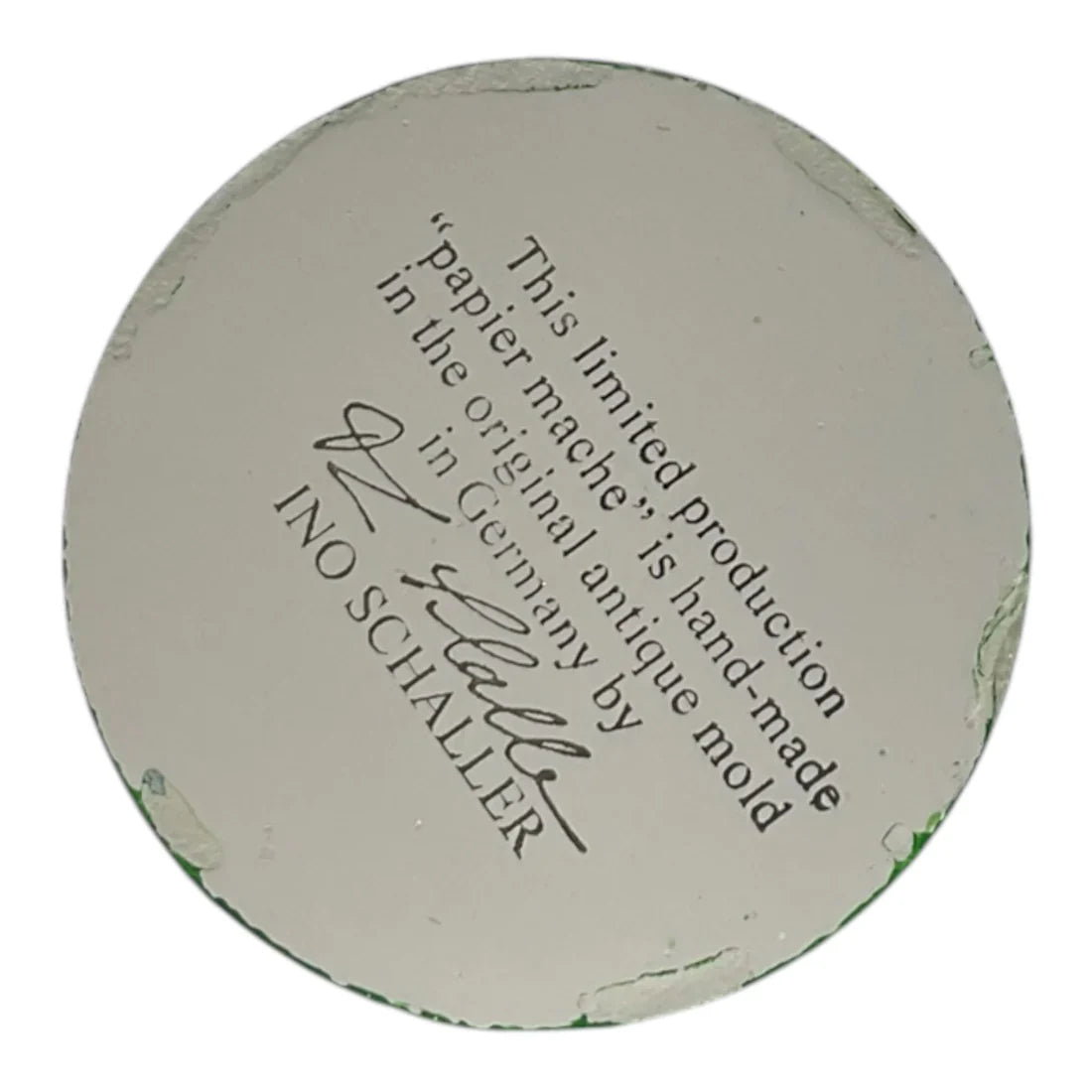Off-white circular german paper mache base with faint green residue from ino schaller easter bunny product