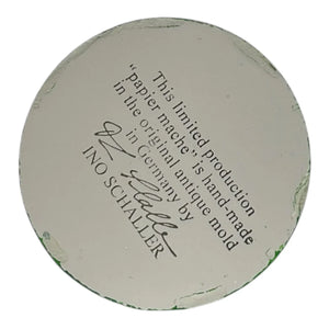 Off-white circular german paper mache base with faint green residue from ino schaller easter bunny product