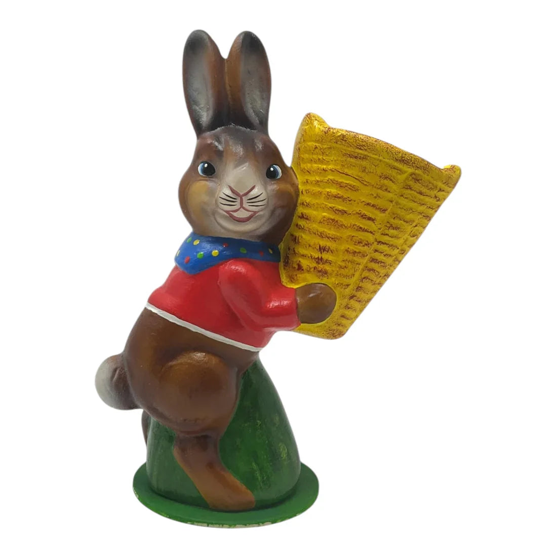 A charming ino schaller easter bunny figurine in german paper mache holding a yellow basket and wearing a red shirt