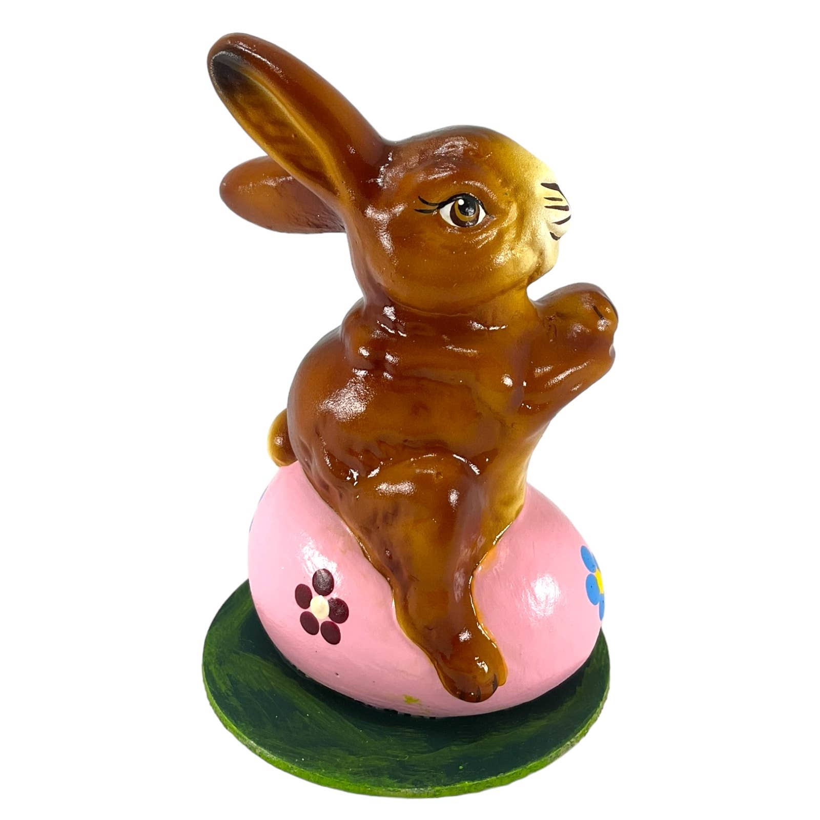 Glossy brown hand-painted paper ino schaller easter rabbit figurine sitting on a pink floral egg with green base