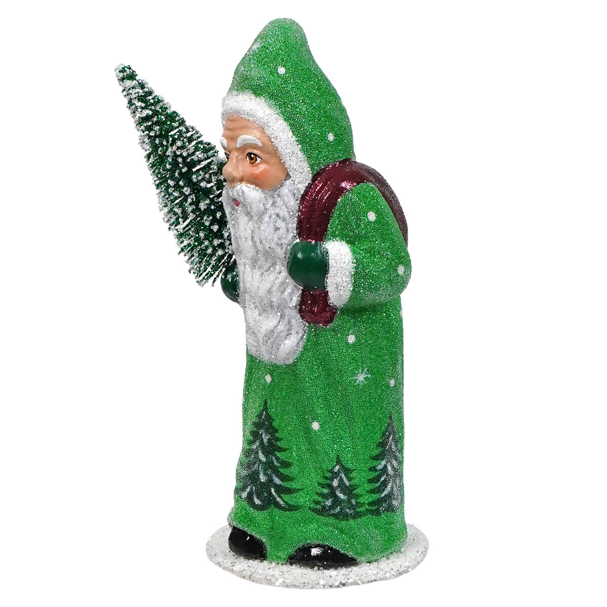 Green-robed Santa Claus figurine holding a miniature Christmas tree.