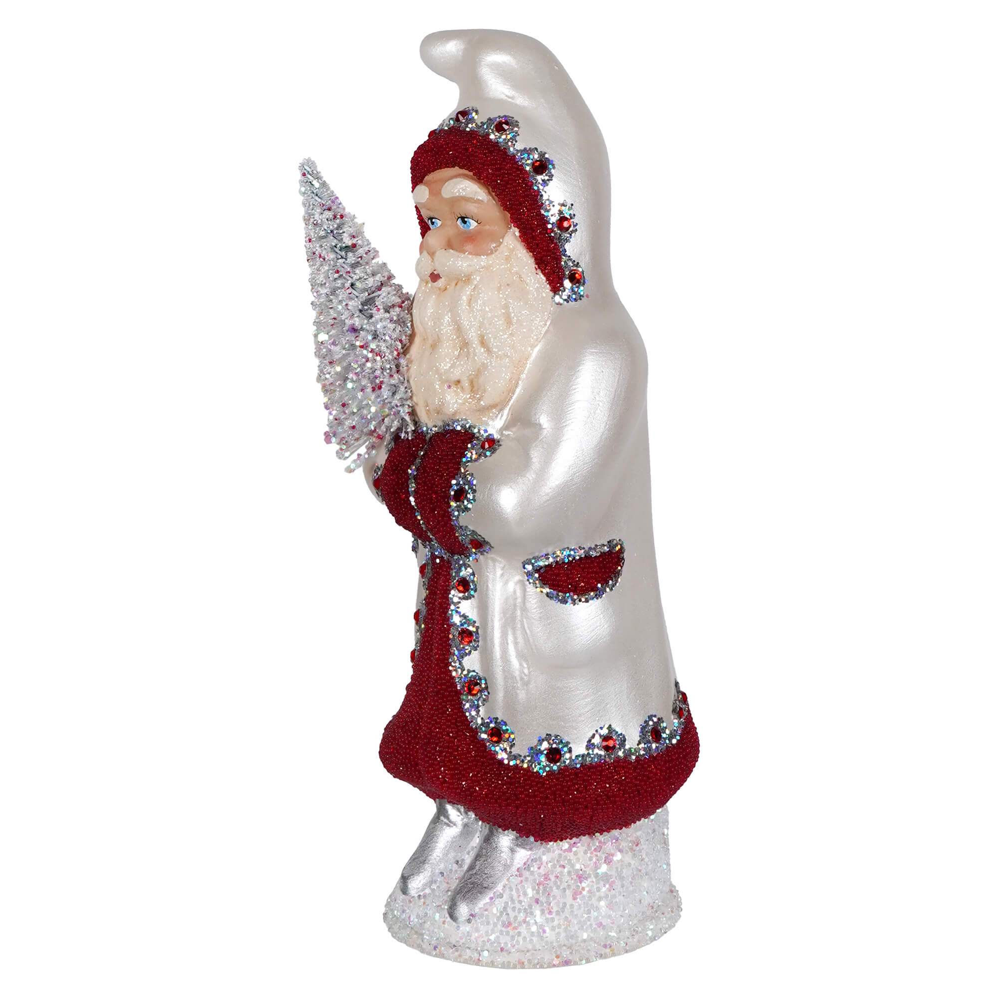 A festive ino schaller pearl white santa figurine with red glitter trim and rhinestones holding a silver frosted tree