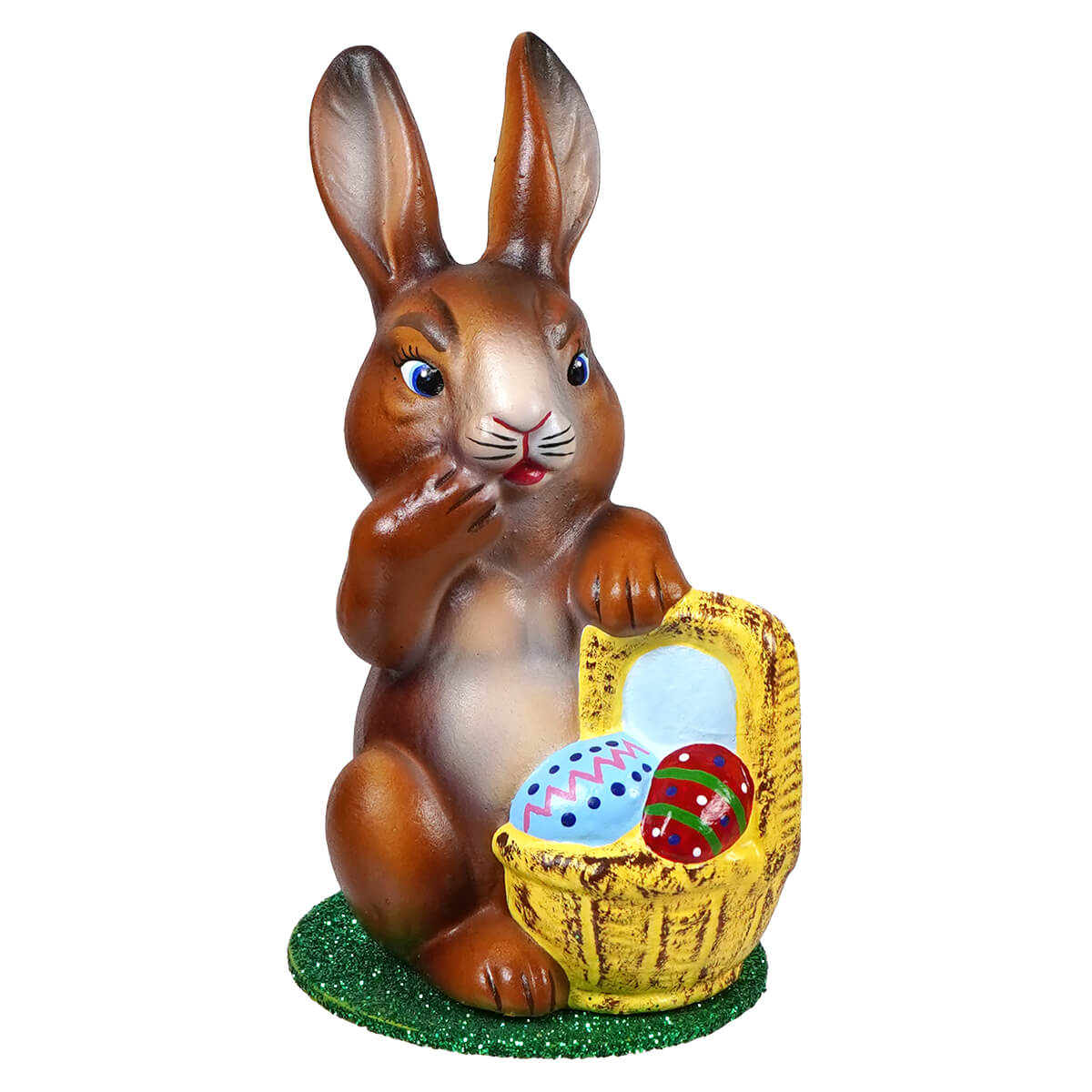 Ino schaller sitting brown ceramic easter bunny holding a yellow basket filled with colorful decorated eggs