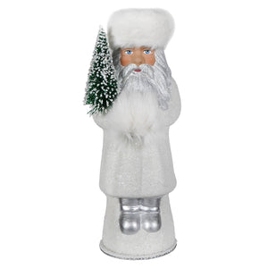 A glittery silver beaded russian santa with fluffy white schaller white coat holding a frosted green christmas tree