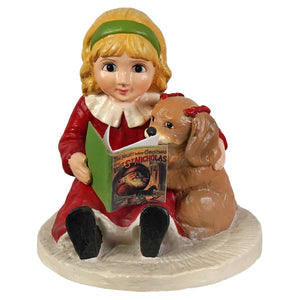 A bethany lowe porcelain figurine of a girl in a red dress reading the night before christmas to a puppy with a red bow