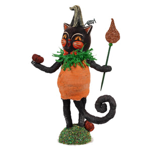 Black cat figurine dressed in orange pumpkin costume with green tinsel collar holding glittery torch and apple jack o cat