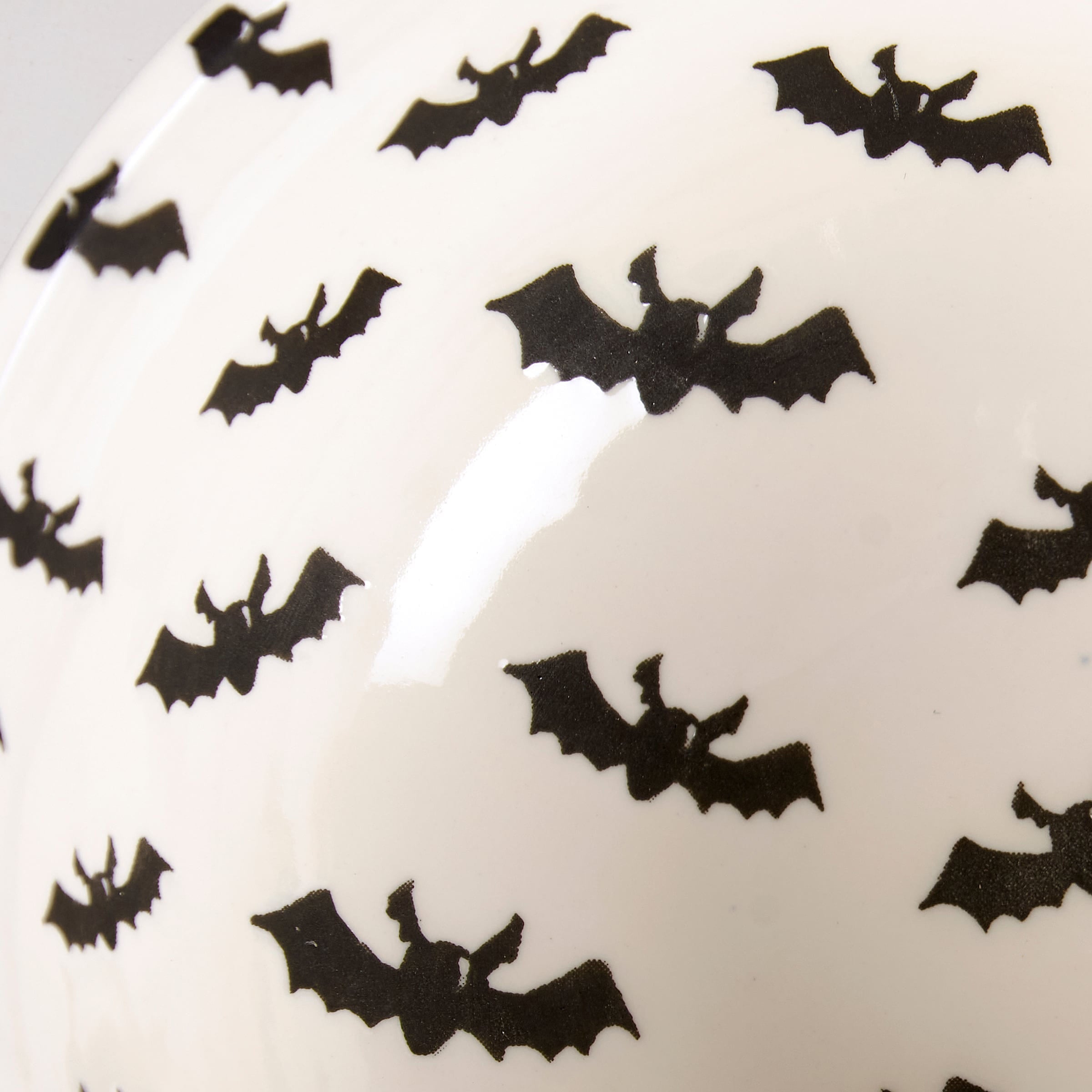 White ceramic jack o lantern bowl with black bat pattern perfect for spooky bowl set decor